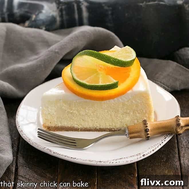 A slice of margarita cheesecake on a white plate, garnished with citrus slices, ready to be enjoyed.