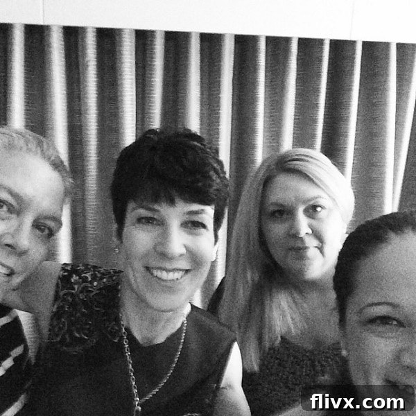 Three friendly food bloggers smiling at a conference, representing connection in the culinary world.