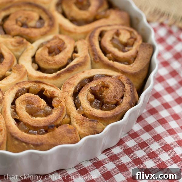Unfrosted Apple Cinnamon Rolls in a round white baking dish.