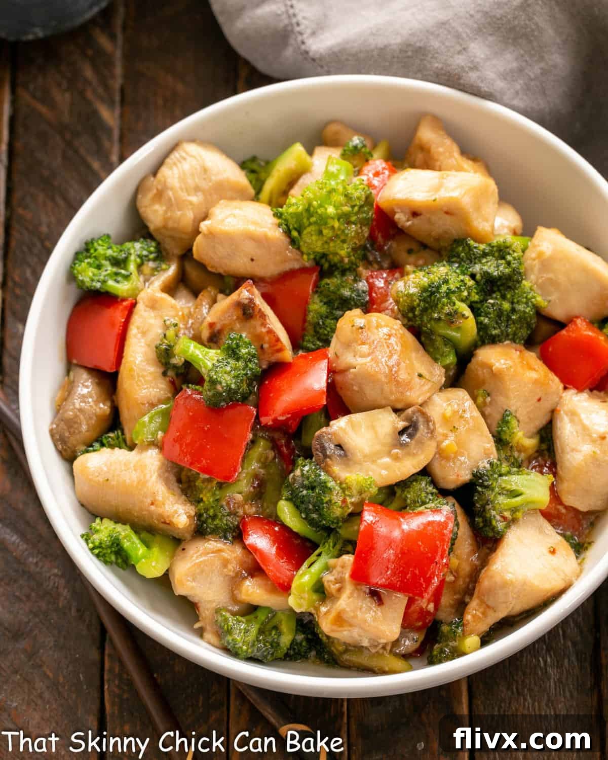 Overhead view of a serving bowl full of delicious chicken and broccoli stir fry, ready to eat.