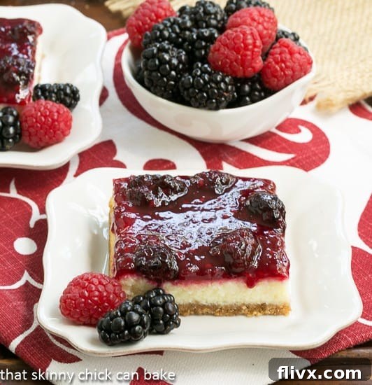 Elegant Berry Topped Cheesecake Bars with fresh mixed berries