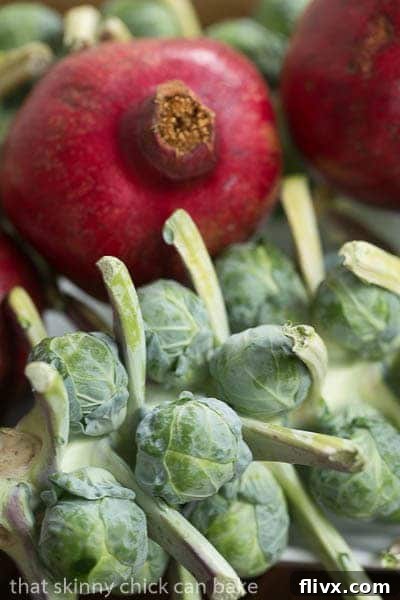 Fresh Brussels sprouts still attached to the stalk, showcasing their natural growth and vibrant green color.