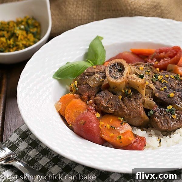 Osso Buco a L'arman in a white bowl over rice topped with orange gremolata.