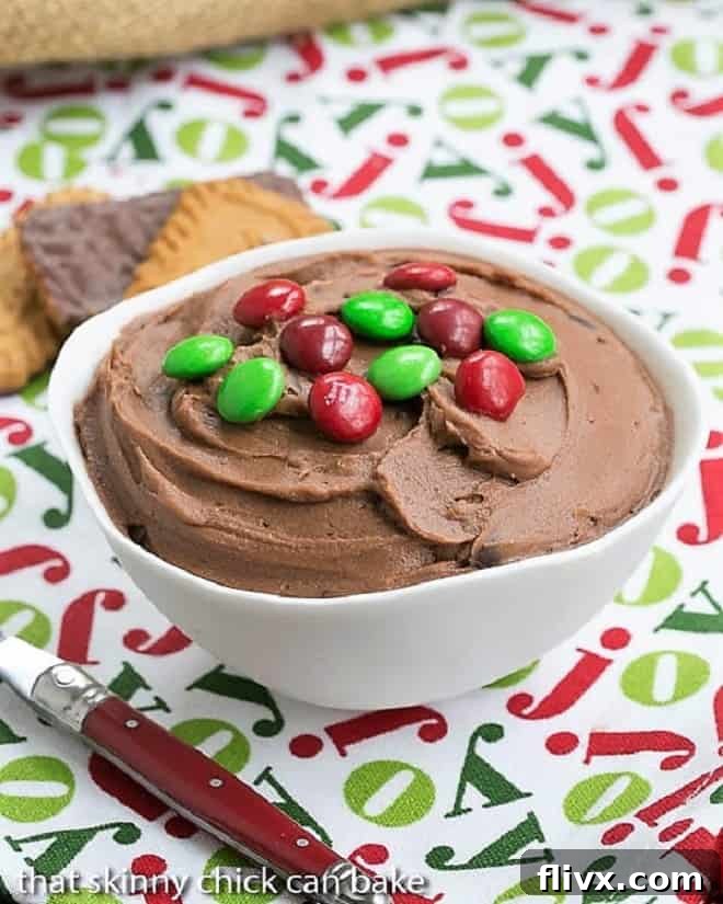 Brownie Batter Dip in a white serving bowl topped with M & M's