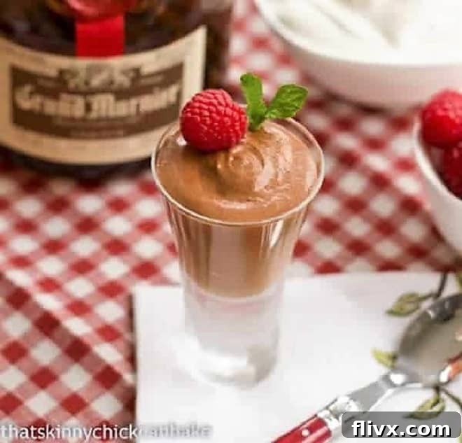 A small cordial glass filled with rich, airy Classic French Chocolate Mousse with Grand Marnier, perfectly set and ready to enjoy.