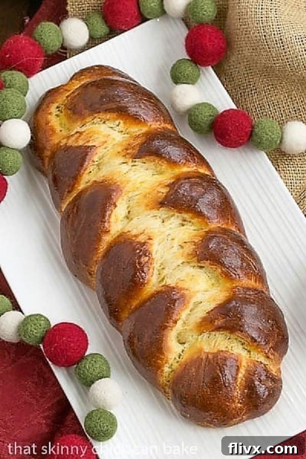Overhead view of a perfectly braided Swiss Butter Braid (Butterzopf) on a white platter, showcasing its golden crust and inviting texture.