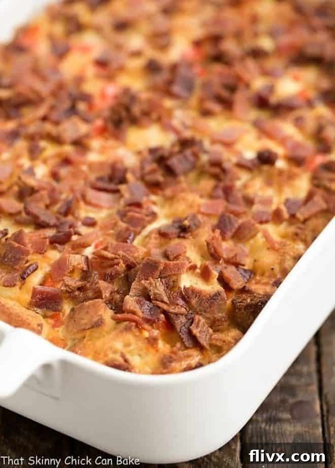 The full Easy Bacon and Egg Strata in a pristine white ceramic casserole dish, ready to be served or baked, showcasing its inviting layers.