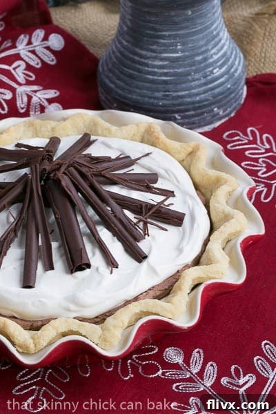 Whole Black Bottom Chocolate Mousse Pie, beautifully garnished with chocolate curls, resting in a festive red pie plate.