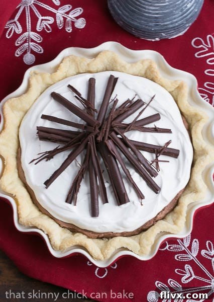 Overhead shot of the completed Black Bottom Chocolate Mousse Pie on a charming red and white checkered cloth, inviting a slice.