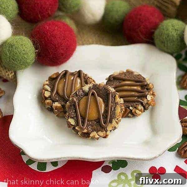 Delightful Turtle Thumbprint Cookies on a square white plate, perfectly baked with caramel centers and pecan halves.