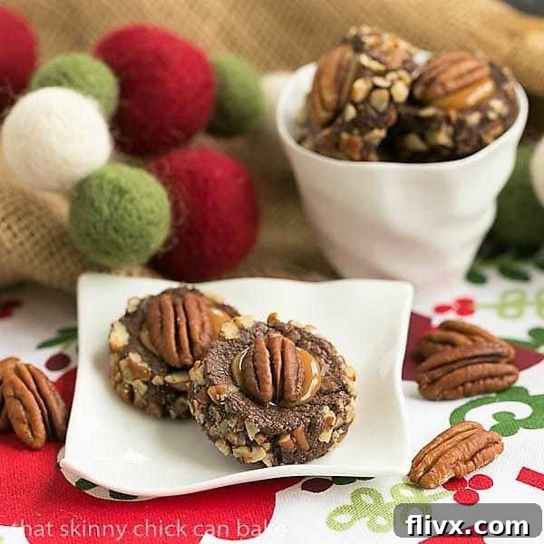 Close-up of a Thumbprint Cookie Recipe on a small white ceramic plate, featuring a pile of caramel-filled chocolate cookies.