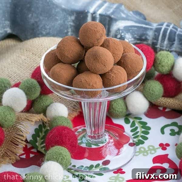 Caramel Filled Chocolate Truffles piled elegantly on a glass pedestal, ready to be enjoyed as a luxurious dessert or holiday treat.