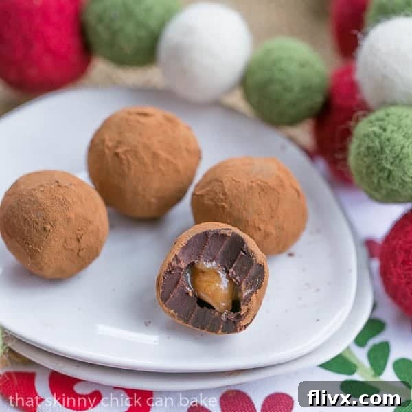 A Caramel Filled Chocolate Truffle cut in half, revealing its gooey vanilla caramel interior, surrounded by rich chocolate.