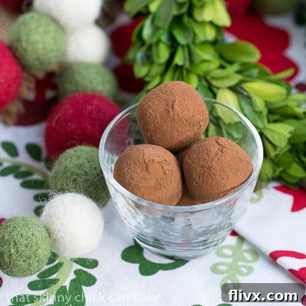 A charming glass candy dish overflowing with perfectly round Caramel Filled Chocolate Truffles, ready for sharing.