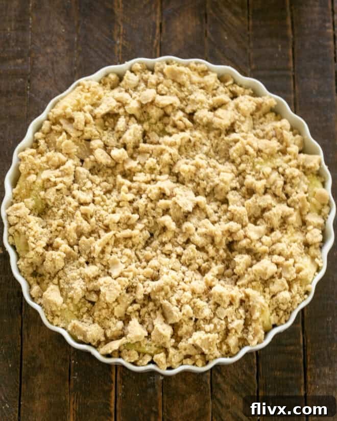 Apple crisp with crumbly topping added over the fruit.