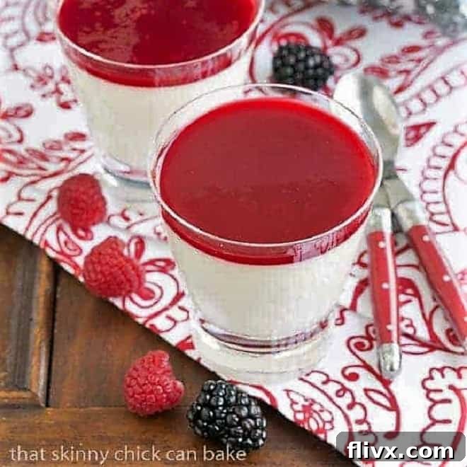 Vanilla Bean Panna Cotta in glasses on a red and white patterned napkin with fresh berries