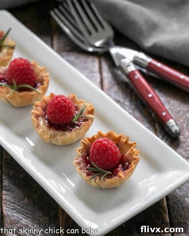 Baked Brie appetizers arranged neatly on a white serving tray, ready for guests