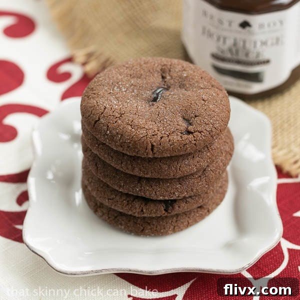 A stack of golden-brown Chocolate Lava Cookies with visible cracks, indicating a molten center, on a square white plate.