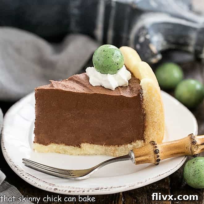 A slice of Irish Mousse Cake on a round white cake plate with a fork.
