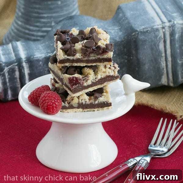 Chocolate Raspberry Crumb Bars on a small white pedestal