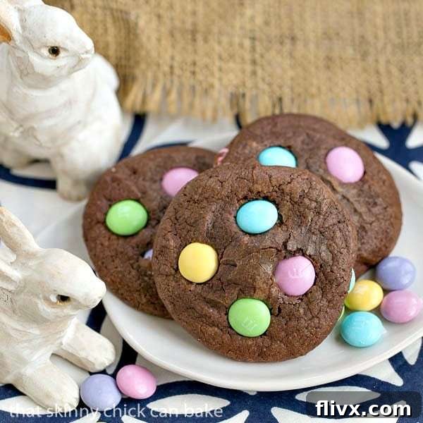 Chewy Easter Candy Brownie Cookies presented on a pristine white tray, adorned with pastel M&Ms.