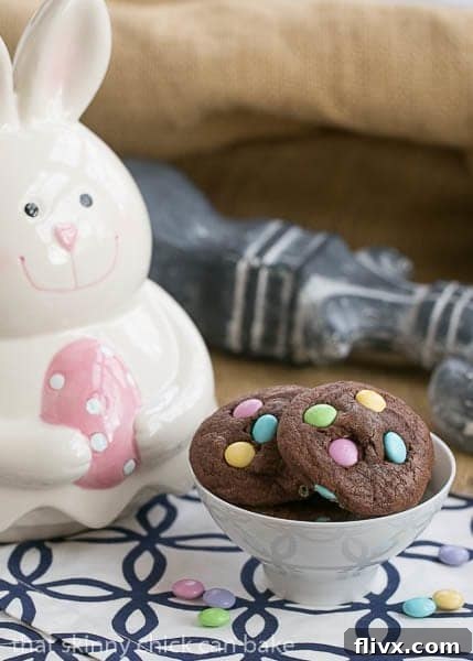 Overhead view of rich Chocolate Cookies garnished with festive Easter M&Ms, ready for enjoyment.