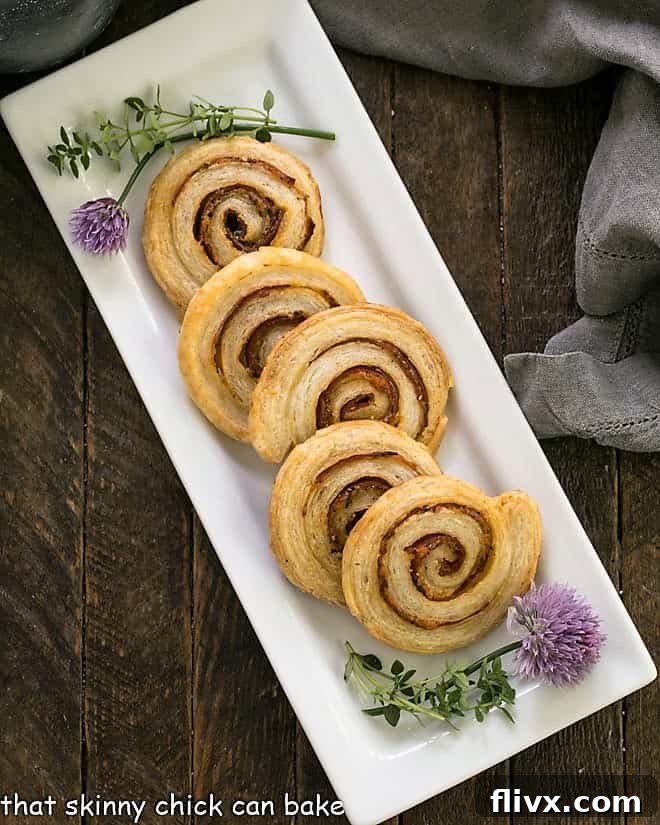 overhead view of pepperoni pinwheels on a white ceramic tray