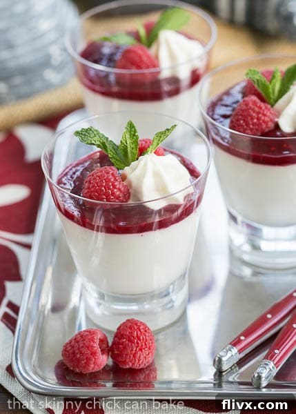 Side view of a tray of beautifully layered Raspberry White Chocolate Cheesecake Parfaits, showcasing the distinct creamy and fruity layers.