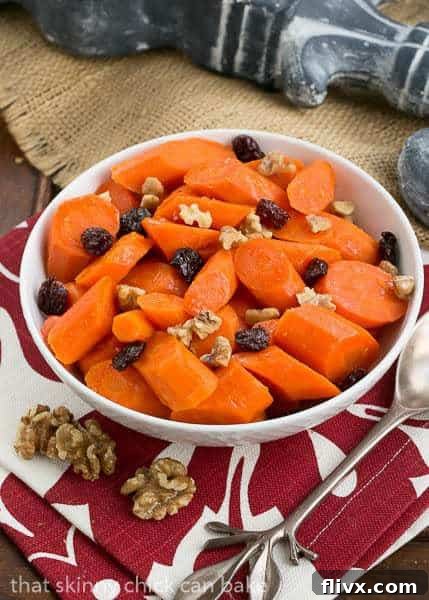 A bowlful of Orange Glazed Carrots on a red and white napkin, beautifully arranged