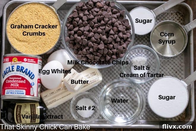 Dreamy Smores Fudge Bars 3 All the fresh, high-quality ingredients for S'mores Fudge Bars laid out neatly on a baking sheet, ready for precise measurement and preparation. Includes graham crackers, chocolate chips, eggs, sugar, and more.