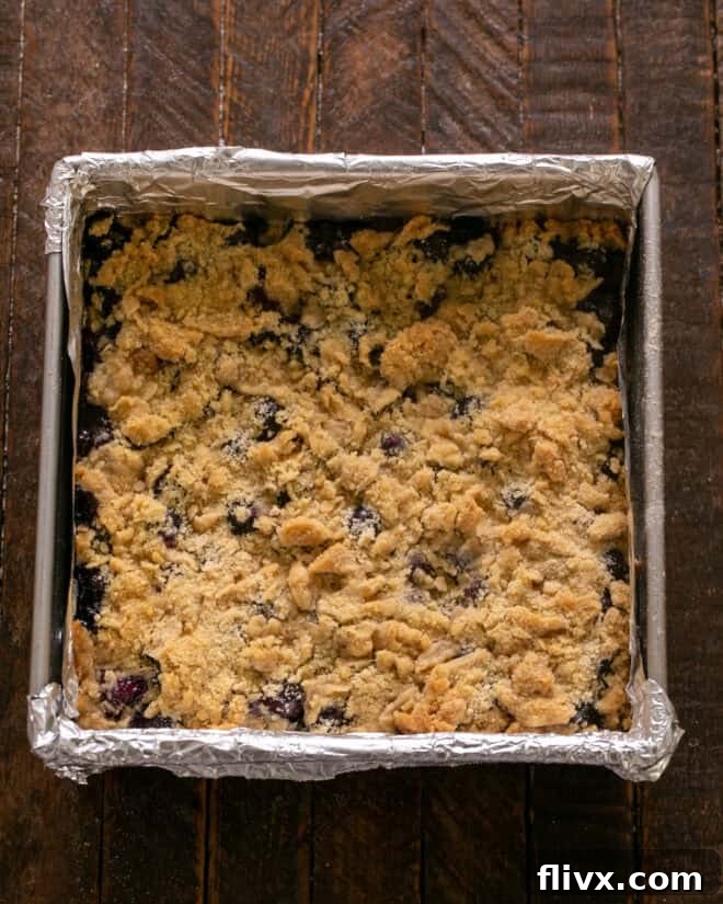 The blueberry streusel bars baking in the oven until golden brown and bubbly.