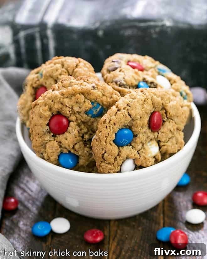 A bowl of freshly baked Patriotic Monster Cookies with red, white, and blue M&Ms, perfect for holiday celebrations