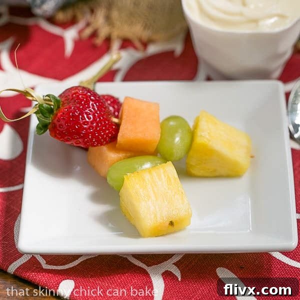 Two Fruit Kebabs with White Chocolate Mascarpone Dip on a square white plate, ready to be enjoyed.