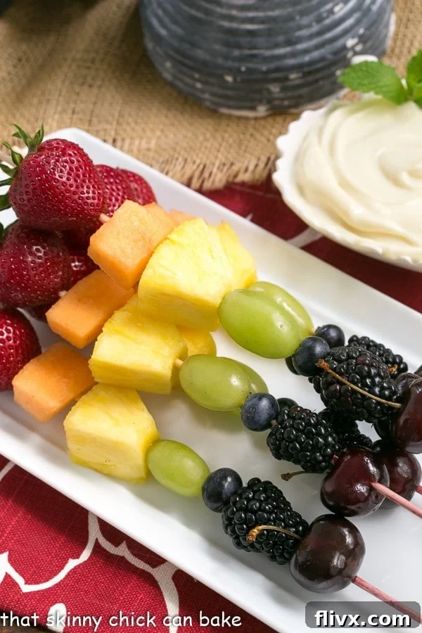 Fruit Kebabs with White Chocolate Mascarpone Dip on a rectangular white ceramic tray, showcasing a beautiful arrangement.