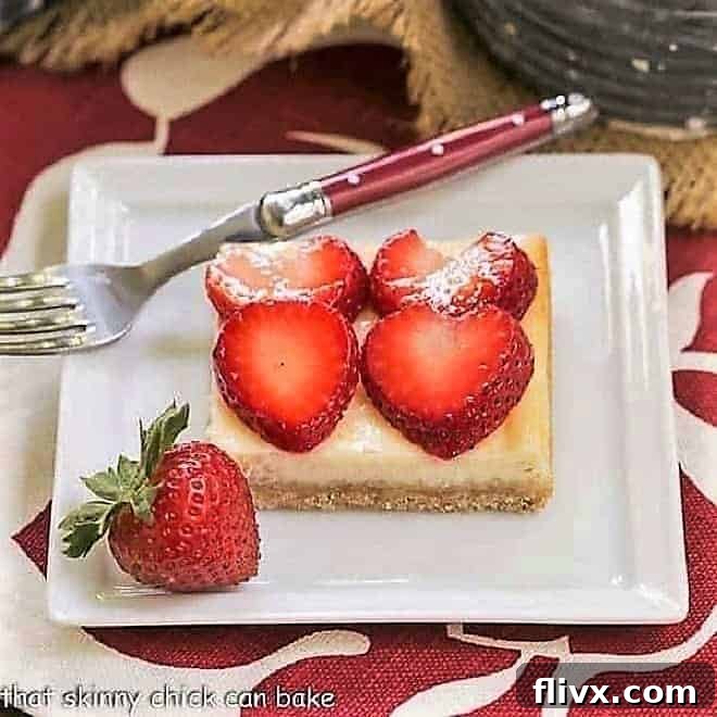 A single Strawberry Cheesecake Bar elegantly placed on a square plate, accompanied by a charming red-handled fork.