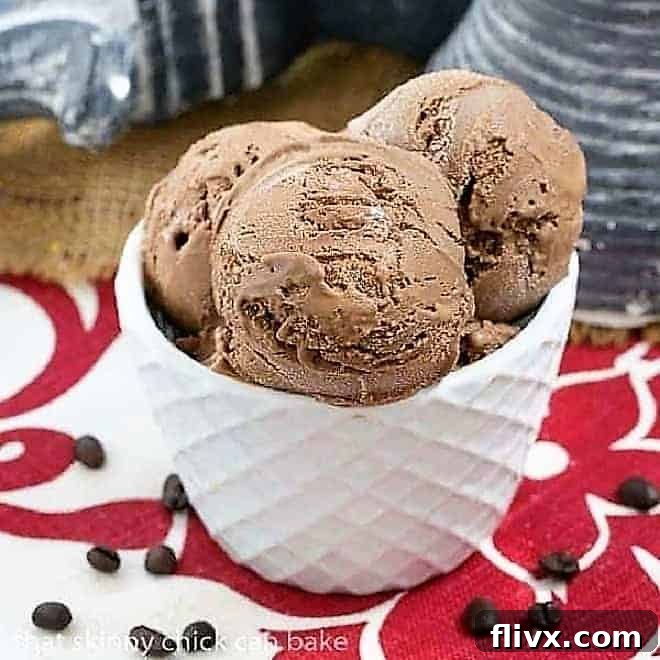 A beautifully textured ceramic bowl filled with creamy mocha ice cream, generously topped with a pillow of homemade marshmallow cream sauce. The light brown ice cream contrasts beautifully with the stark white, fluffy sauce, hinting at a luxurious and indulgent dessert. 