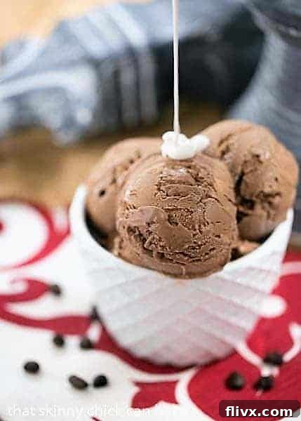 Creamy mocha ice cream in a pristine white bowl is being generously topped with a cascade of homemade marshmallow cream sauce, creating a tantalizing dessert moment. The light, airy sauce contrasts beautifully with the smooth ice cream, inviting indulgence.