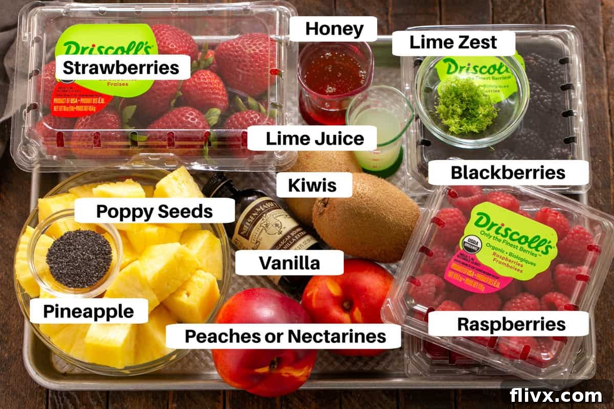 Honey Lime Fruit Salad Ingredients on a sheet pan with labels.