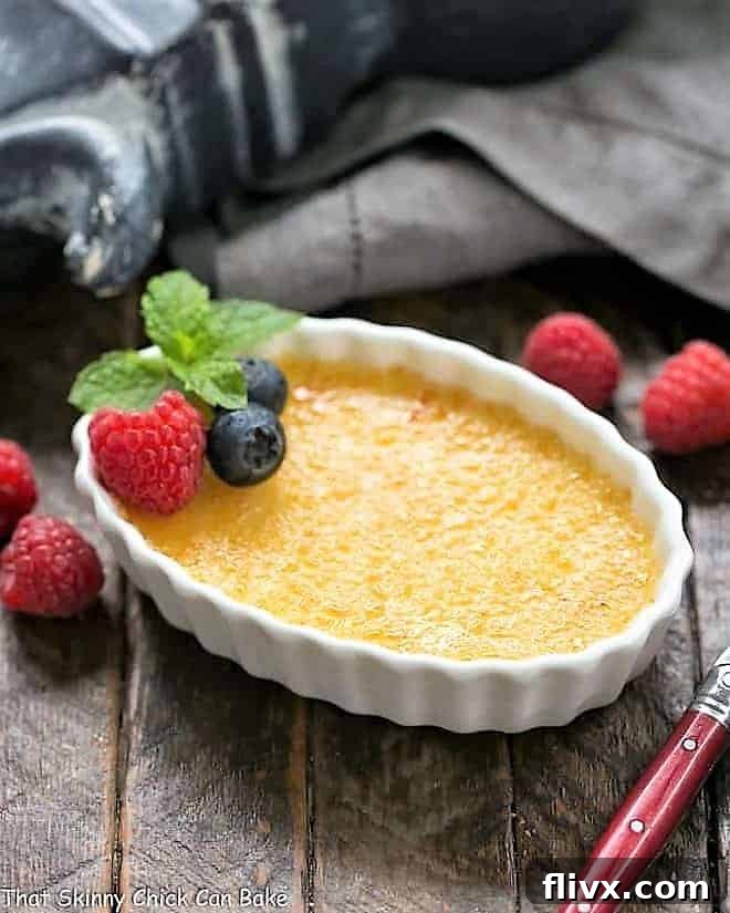 A pristine white ramekin holding a serving of White Chocolate Crème Brûlée, showcasing the contrasting textures of the smooth custard and the perfectly torched, golden-brown sugar topping.