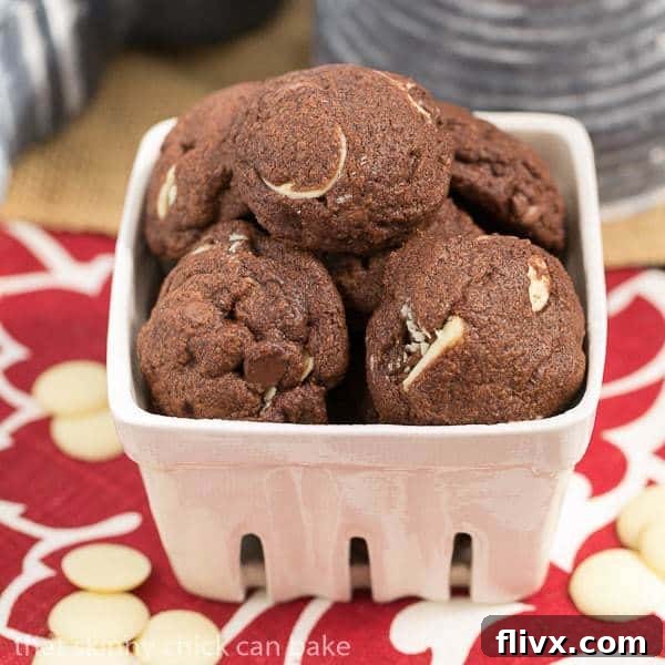 Triple chocolate chip cookies - Double chocolate dough with semisweet, milk and white chocolate chips A charming white ceramic basket overflowing with freshly baked Triple Chocolate Chip Cookies, each one a testament to their rich flavor and appealing texture.