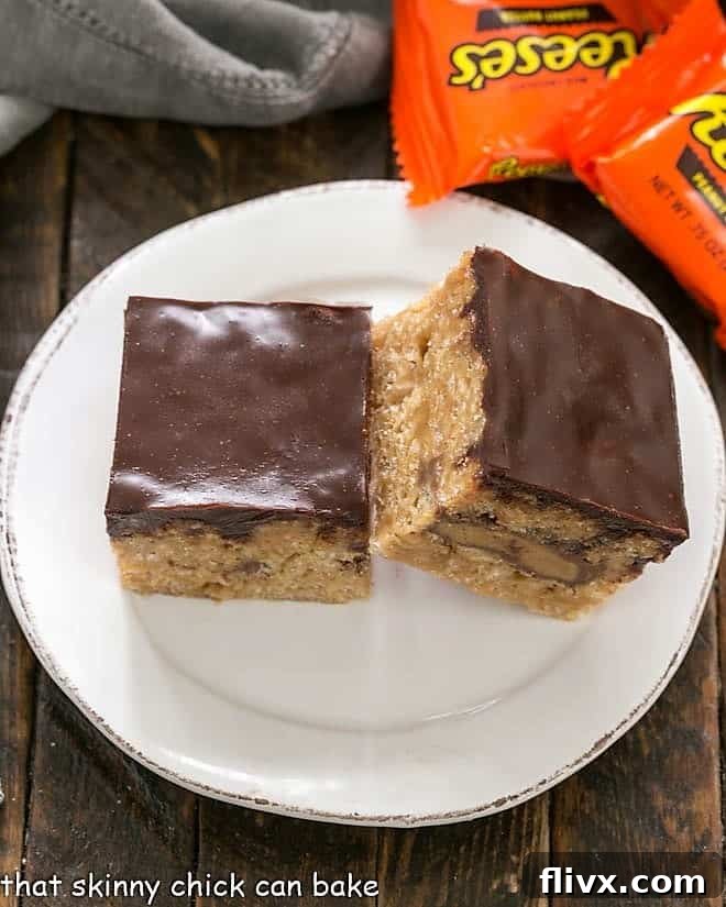 Two Stuffed Peanut Butter Rice Krispie Treats on a round white plate, showcasing a delightful cross-section of the layers, topped with a smooth chocolate ganache.