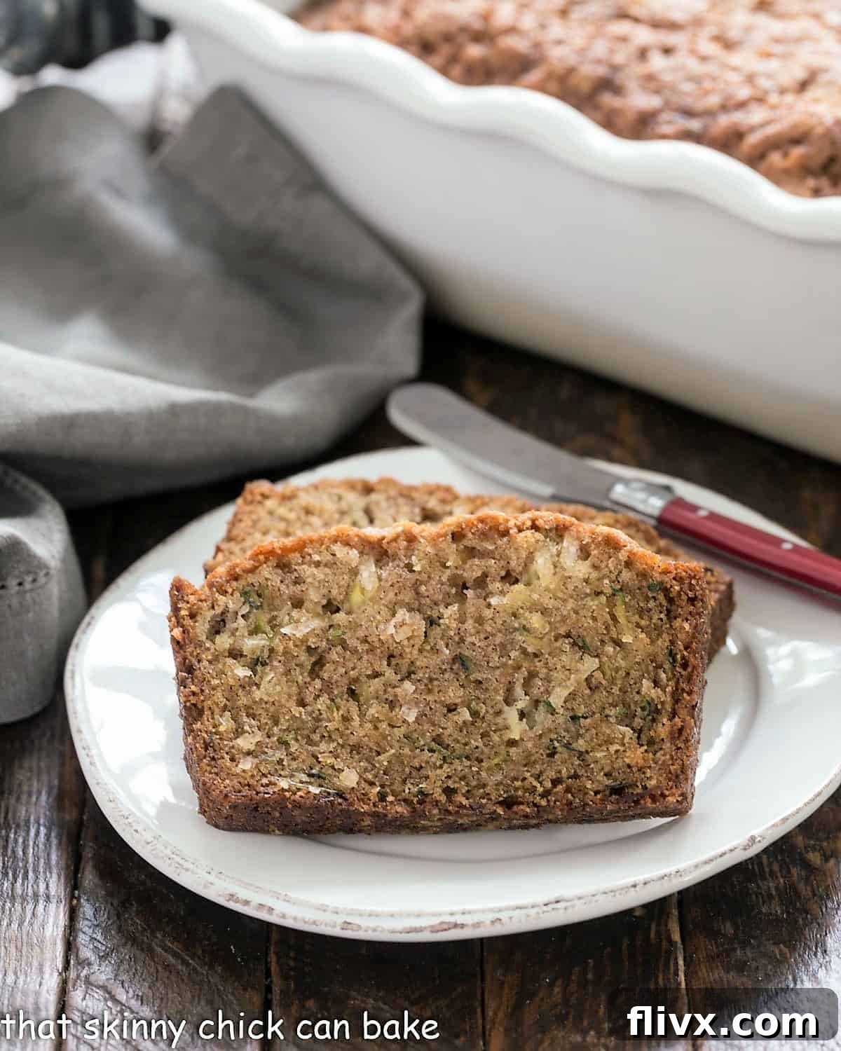 Slices of moist pineapple coconut zucchini bread artfully arranged on a white ceramic platter, showcasing the golden-brown crust and inviting interior.