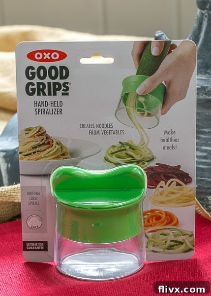 The OXO hand-held spiralizer in action, creating perfect Zucchini Noodles for a healthy meal.