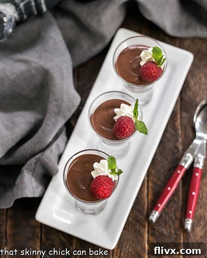 An inviting overhead view of multiple servings of Blender Chocolate Mousse, meticulously arranged in elegant glasses on a clean white ceramic tray, highlighting its rich texture and perfect presentation.