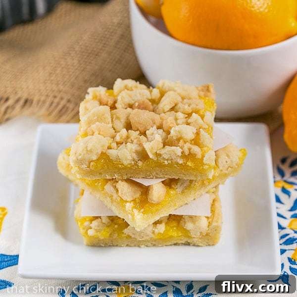A stack of Meyer Lemon Streusel Bars on a square white plate.