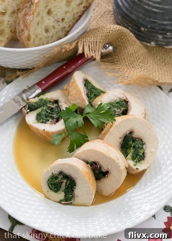 Chicken Spinach and Prosciutto Pinwheels arranged on a white plate