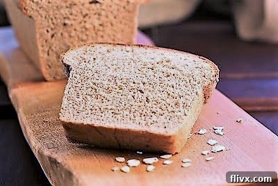 A delectable slice of honey oat bread perfectly toasted and ready to be enjoyed, showcasing its inviting texture.