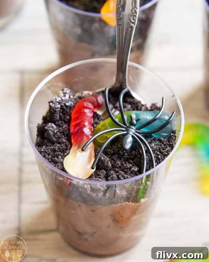 Creepy Crawly Pudding Cups with crushed cookies and gummy worms