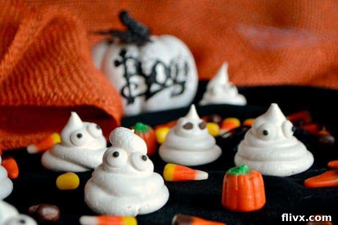 Whimsical Halloween Ghost Meringues with drawn faces