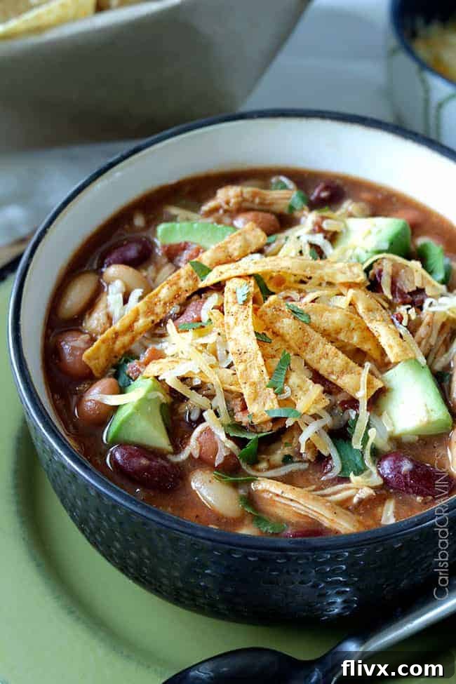 Hearty BBQ Chicken Chili in a bowl, topped with cheese and cilantro